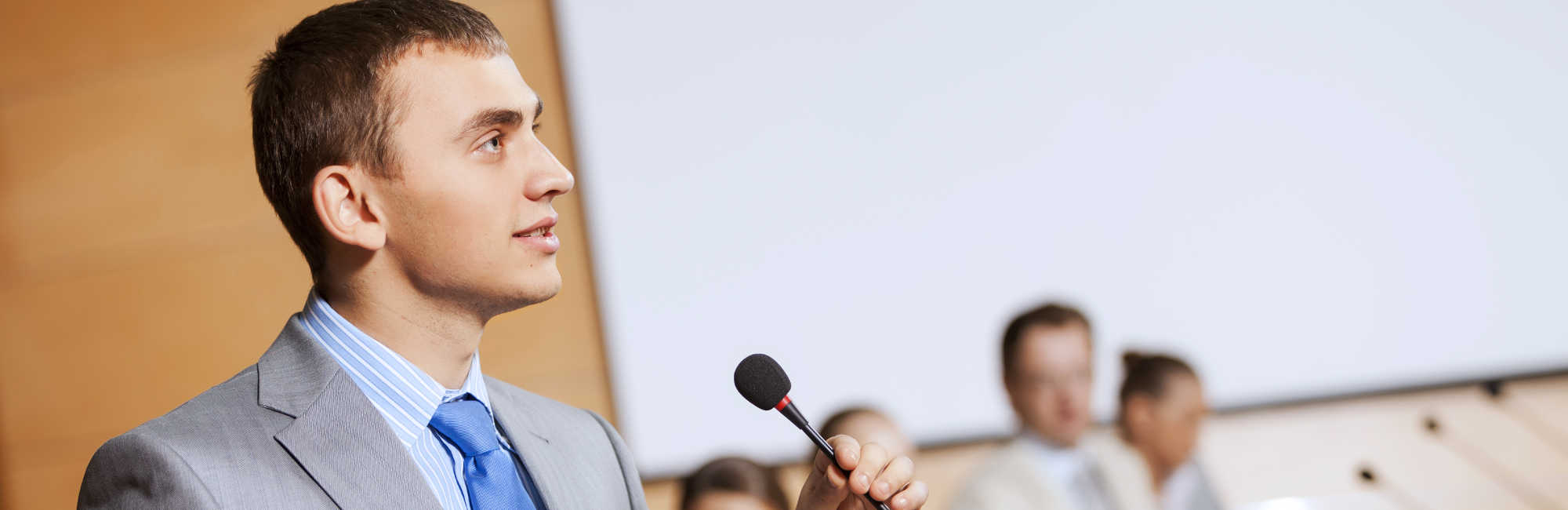 Businessman Public Speaking with Microphone